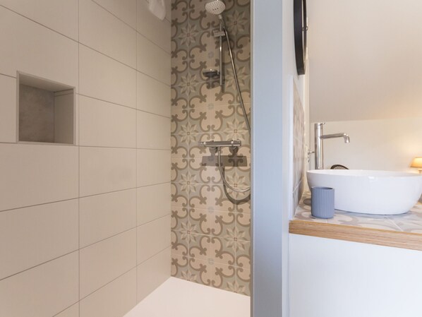 A modern bathroom with a shower, a bathtub, and a toilet.
