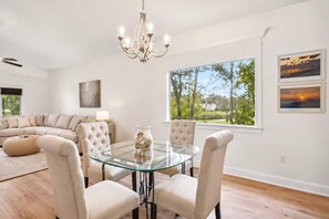 Bright dining area with elegant decor and serene tree-lined views