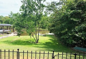 Private waterfront lawn with shady trees and easy dock access