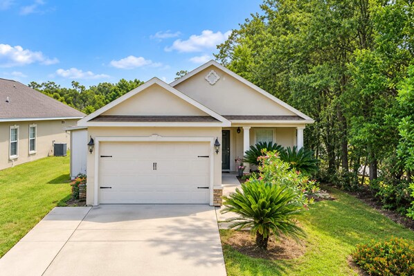 Charming single-story home with lush landscaping and inviting curb appeal