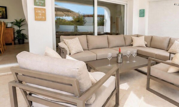 A modern living room with a beige sofa, a wooden coffee table, and a glass of wine. - Colina - modern 3 bedroom villa close to town/beaches (Moraira)