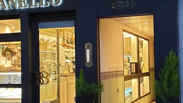 A storefront with the name "LANELLO" and a sign indicating "PIZZA RESTAURANT". - Philips Apartment (Milan)