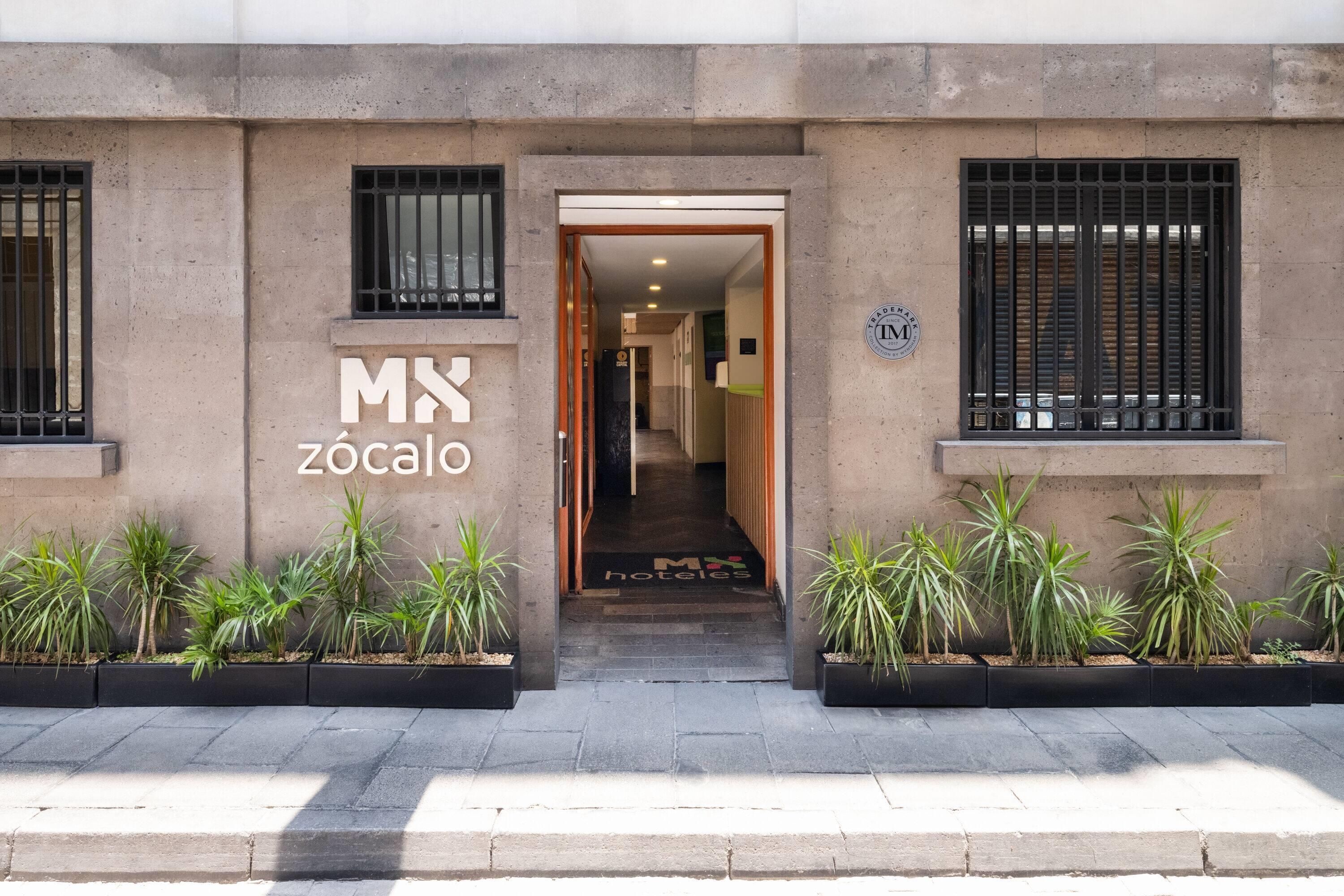 A building entrance with a sign reading 'MX Zócalo' and a logo indicating a trade mark.
