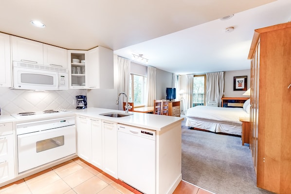 Tabla de planchar con plancha, internet y ropa de cama