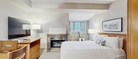 Tabla de planchar con plancha, internet y ropa de cama