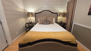 A hotel room with a large bed, two bedside tables with lamps, a headboard, and a curtain. - Standard Guest Room (Main) - Barefoot Hills - North Georgia Mountains (Dahlonega)