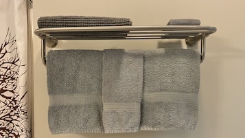 Combined shower/tub, hair dryer, towels, soap