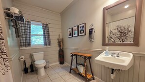 A bathroom with a toilet, sink, and window with curtains. - Standard Guest Room (Main) - Barefoot Hills - North Georgia Mountains (Dahlonega)