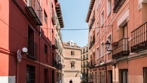 A narrow street with buildings on both sides, featuring balconies and a cobblestone path. - Stylish Apt PZA MAYOR / La Latina 2BD * 2BT *, 6p max (Madrid)