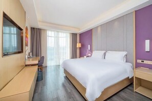 A modern hotel room with a large bed, a desk, a TV, and a view of the outdoors. - Lavande Hotel (Beijing Changping Stadium) (Changping)