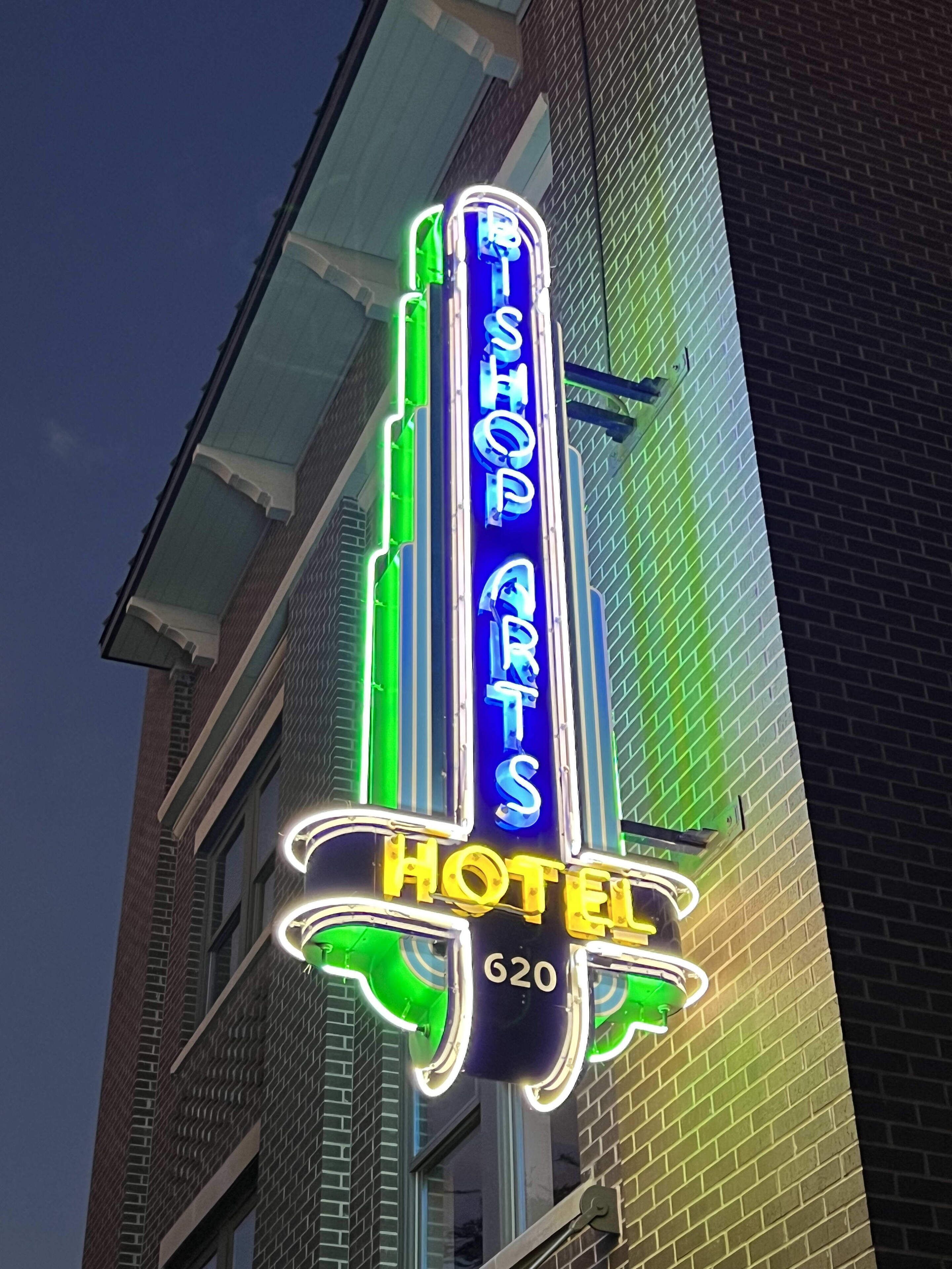 A neon sign for 'T Shop Arts Hotel' with the number 620.