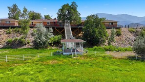 A residential area with a gazebo, a staircase leading to a house, and a mountainous backdrop. - Prestige Mountain View with a relaxing Waterfront at Arkansas River. (Howard)