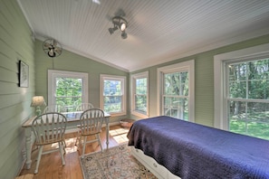 Relax in a traditional room with a comfortable bed, desk, and two chairs.