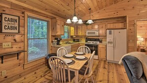 A cabin-style kitchen with wooden walls and ceiling, a dining table with chairs, a refrigerator, and a microwave. - 'Pinot & Pine' Chic Log Cabin ~ 5 Mi to Blue Ridge (Blue Ridge)
