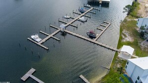 An aerial view of a marina with docks and boats. - Spacious condo across beach access! Bring your boat! Dock slips, pool & more! (Orange Beach)