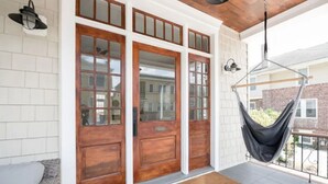 A wooden front door with glass panels, a hanging hammock, and a white tiled wall. - Just redone, 1 1/2 block from Ventnor beach (Ventnor City)