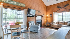 A cozy cabin interior with a dining area, a sofa, and a fireplace. - Relax Fireside! Home 8 Mi to Silver Dollar City (Branson)