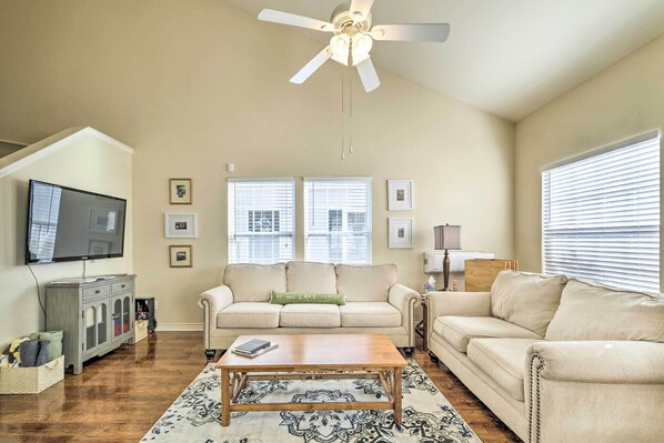 Relax in this inviting living room with a sofa, flat-screen TV, and coffee table.