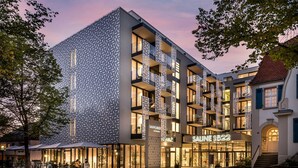 A modern hotel with a patterned facade, multiple balconies, and a well-lit entrance. - Superior Plus - Saline 1822, Hotel Bad Rappenau (Bad Rappenau)