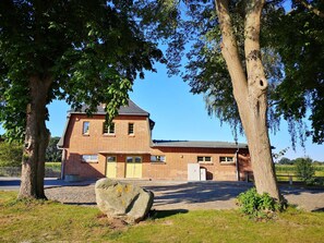 A brick building with a flat roof and a small tower.