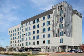 Experience the modern facade of this hotel, featuring a symmetrical design with multiple windows and a prominent entrance.