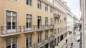 A multi-story building with balconies and large windows.