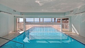 An indoor swimming pool with a view of the ocean. - 2 Bedroom in Ocean Villa Resort -  Beautifully decorated and appointed condo with amazing views! (Panama City Beach)