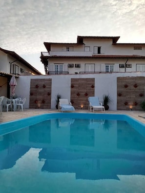 Outdoor pool, open 9:00 AM to 10:00 PM, pool umbrellas, pool loungers