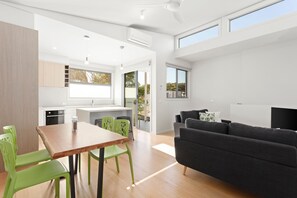 A modern interior with a dining area, kitchen, and living space.