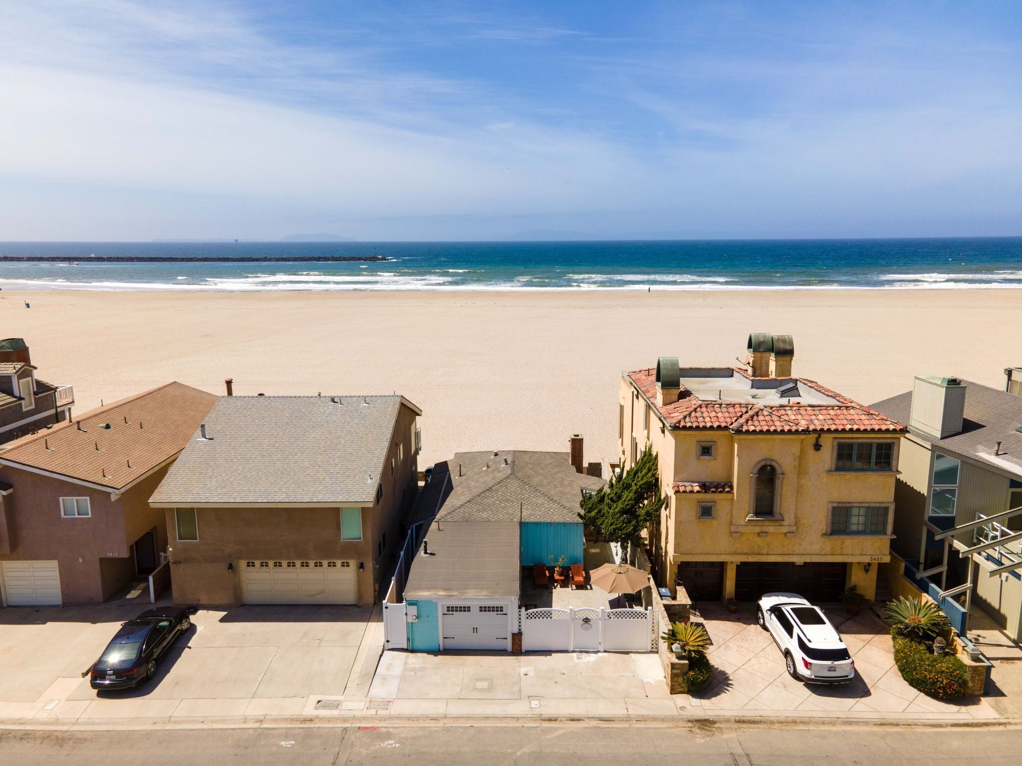 A beachfront property with a garage, a covered patio, and a view of the ocean.