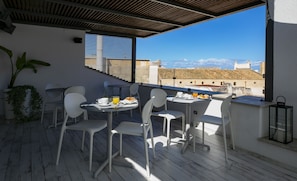 Enjoy casual dining on the outdoor terrace with a city view.
