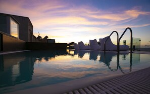 Relax by the serene pool surrounded by a minimalist design and unique sculptural elements.