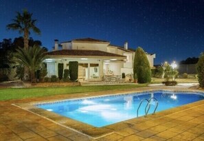 A house with a swimming pool at night. - Large Luxury  Villa , with Large Gardens , pool ,gym and tennis court. (santa pola)