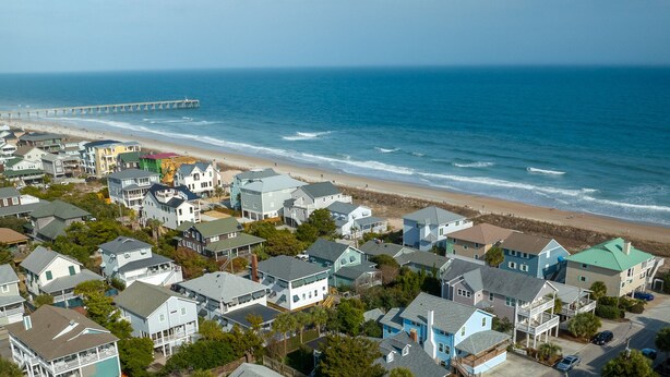 A coastal residential area with houses, a beach, and a pier. - Classic Beach Cottage on Oceanside of Wrightsville Beach-Upper Unit (Wrightsville Beach)