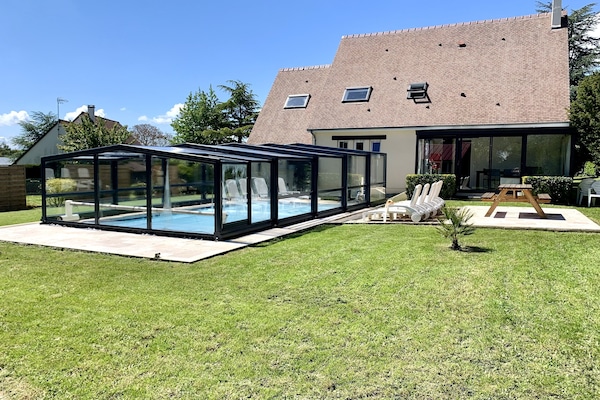 Arrière de la maison avec la piscine (abri fermé), vue sur le jardin &la véranda
