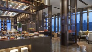 A modern hotel lobby with a buffet area, high ceilings, and large windows offering a city view. - Hyatt Regency Lanzhou (Lanzhou)