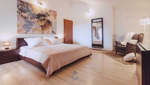 A bedroom with a bed, a nightstand, a desk, a chair, a mirror, and a painting on the wall. - Gorgeous 5-BR Villa with private heatable pool near Pula (Fažana)