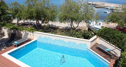 7-BR Beachfront Villa with Seaside Terrace and Heated Swimming Pool