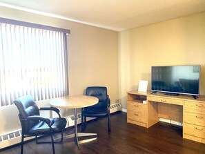 Suite with Ottoman Bed | Living room | 58-inch Smart TV with satellite channels