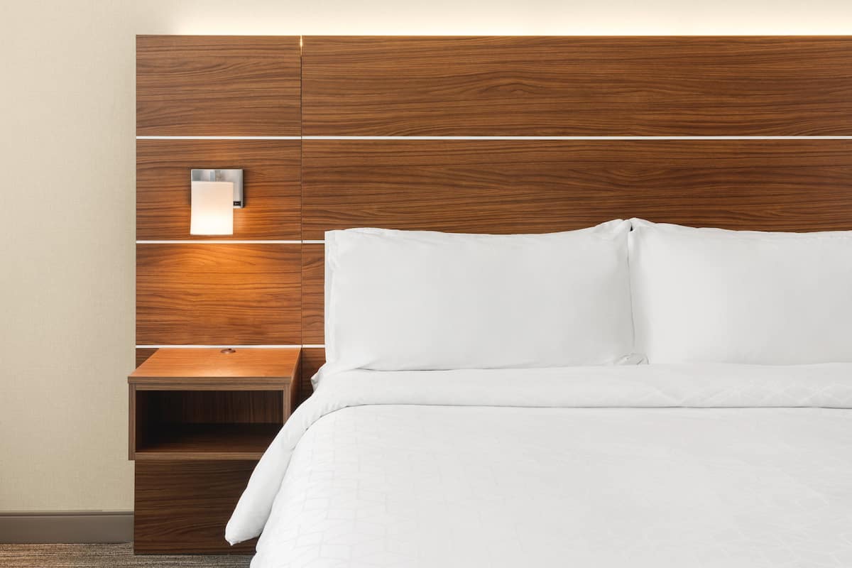 Premium bedding, desk, laptop workspace, blackout drapes