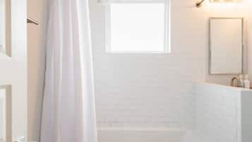 Bathtub, hair dryer, towels, soap
