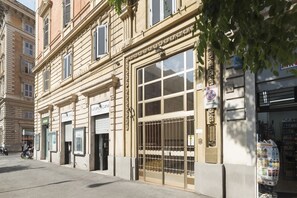 A building with a large window, a metal gate, and a sign that reads 'FATAMORGANA.'