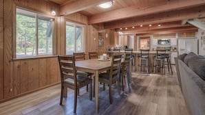 A wooden interior with a dining area, kitchen, and a sofa. - Close drive to lake * Dog OK * Great Family Home (Carnelian Bay)