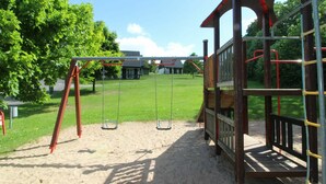 A playground with swings and a climbing structure. - Wonderful private villa for 6 people with WIFI, pool, TV, terrace and pets allowed (Dvur Králové Nad Labem)