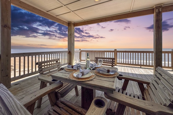 Enjoy unforgettable meals on the covered deck, surrounded by ocean breezes and breathtaking beachfront scenery.