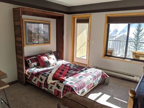 A bedroom with a bed, a window, and a door. - Keystone Condo Next to Lifts & Shuttle Stop, Private Balcony w/ Great Views! (Keystone)