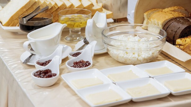 A buffet table with various food items, including fruits, cheeses, and bread. - Stella Hotel (Tashkent)
