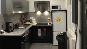 A modern kitchen with a Bosch refrigerator, a microwave, and a coffee maker.