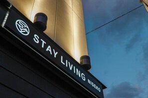 A sign with the text "STAY LIVING NISEKO" against a building facade. - Stay Living NISEKO (Kutchan)