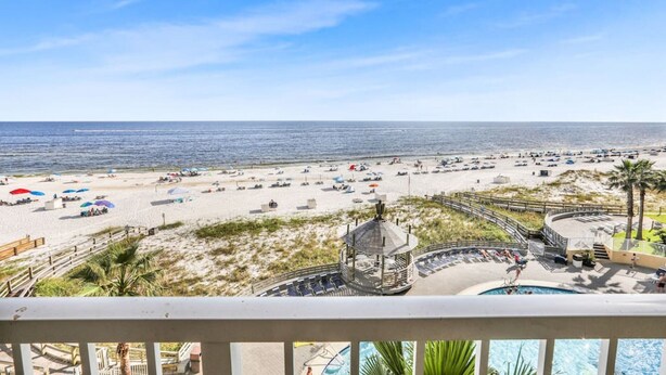 A beach view with a gazebo, pool, and beach umbrellas. - Totally Beachin - Condo with Stunning Ocean Views (Orange Beach)